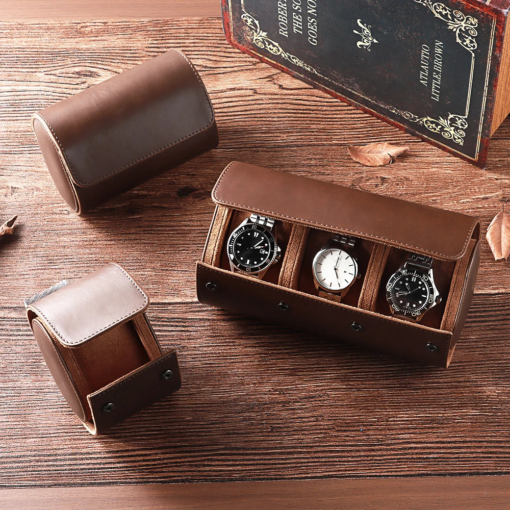 Brown leather watch box with three watches on a wooden surface, featuring the brand 'QINBAN'.